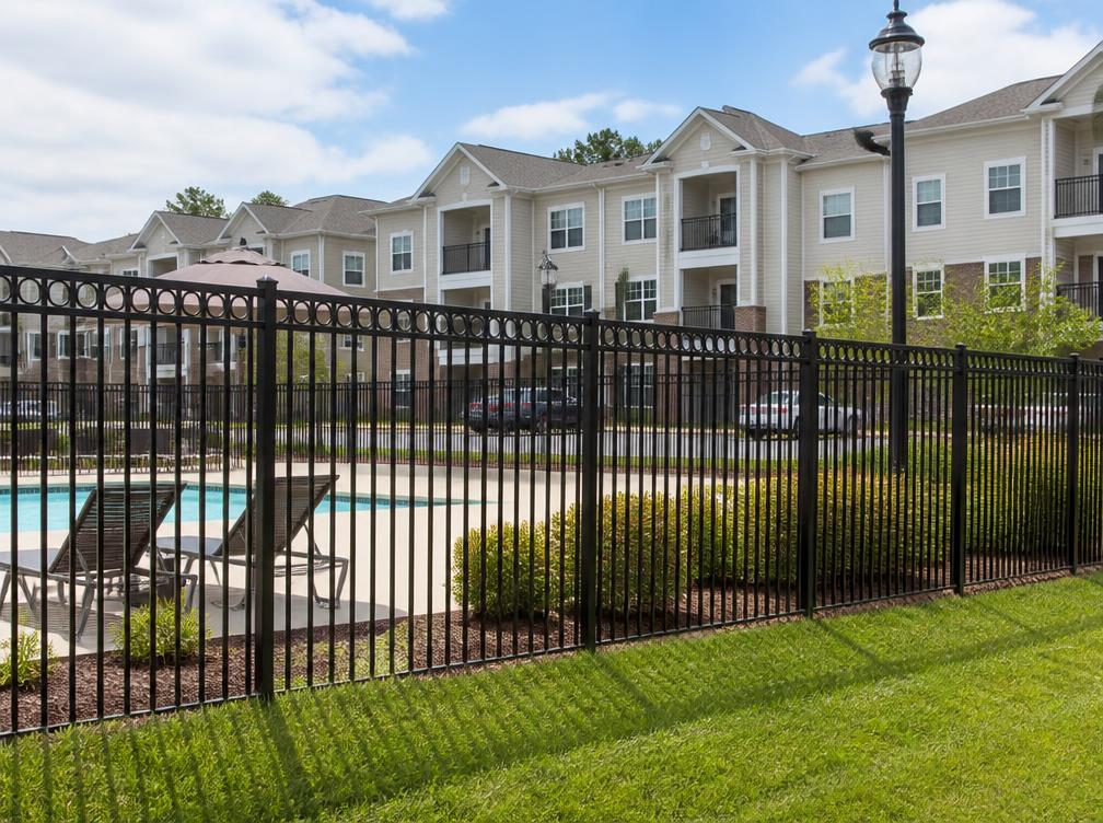Steel perimeter fence around an apartment pool area